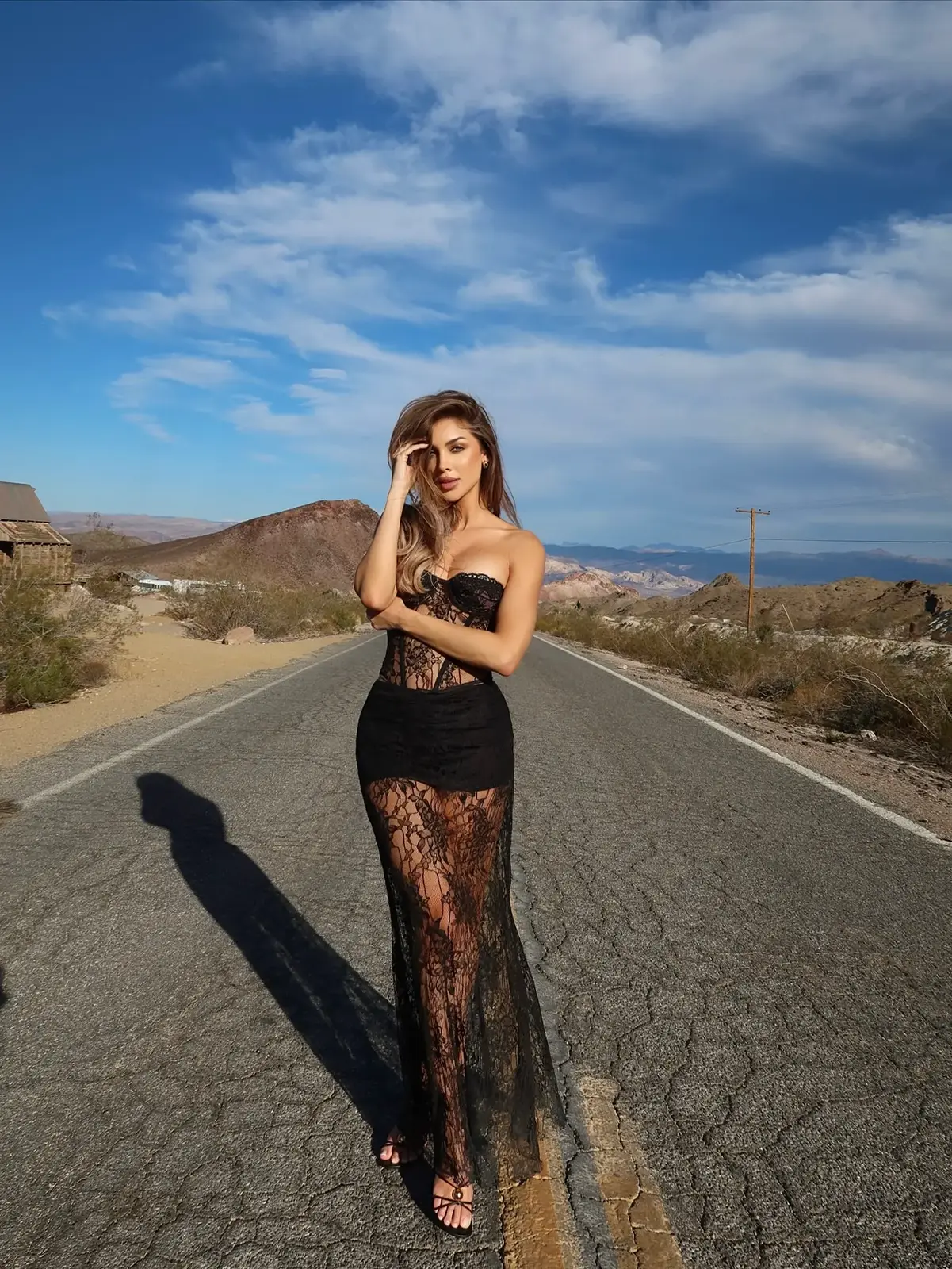 Alternate black lace outfit portrait on the same open road.